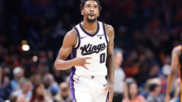 Feb 11, 2024; Oklahoma City, Oklahoma, USA; Sacramento Kings guard Malik Monk (0) gestures after scoring a three point basket against the Oklahoma City Thunder during the second half at Paycom Center. Mandatory Credit: Alonzo Adams-USA TODAY Sports  